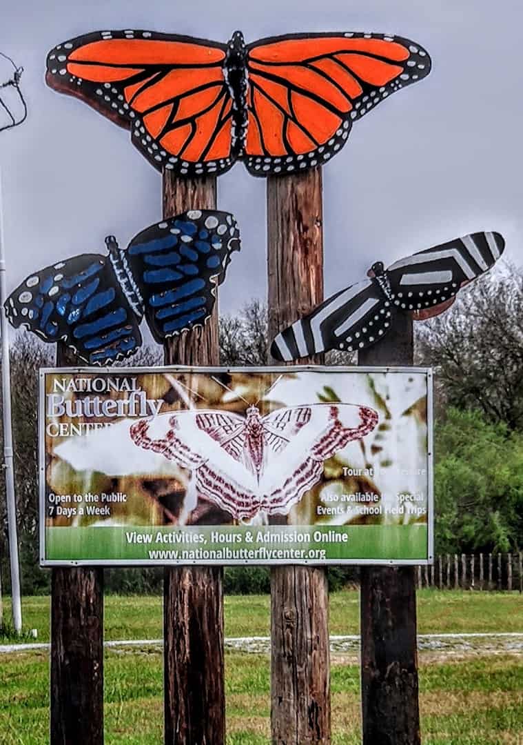 Painted butterfly sculptures on the National Butterfly Center entrance sign in Mission, Texas