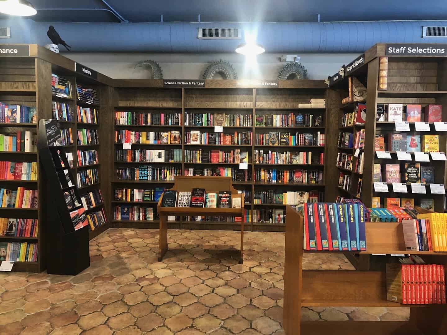 Wooden shelves and staff selections inside Nowhere Bookshop in San Antonio