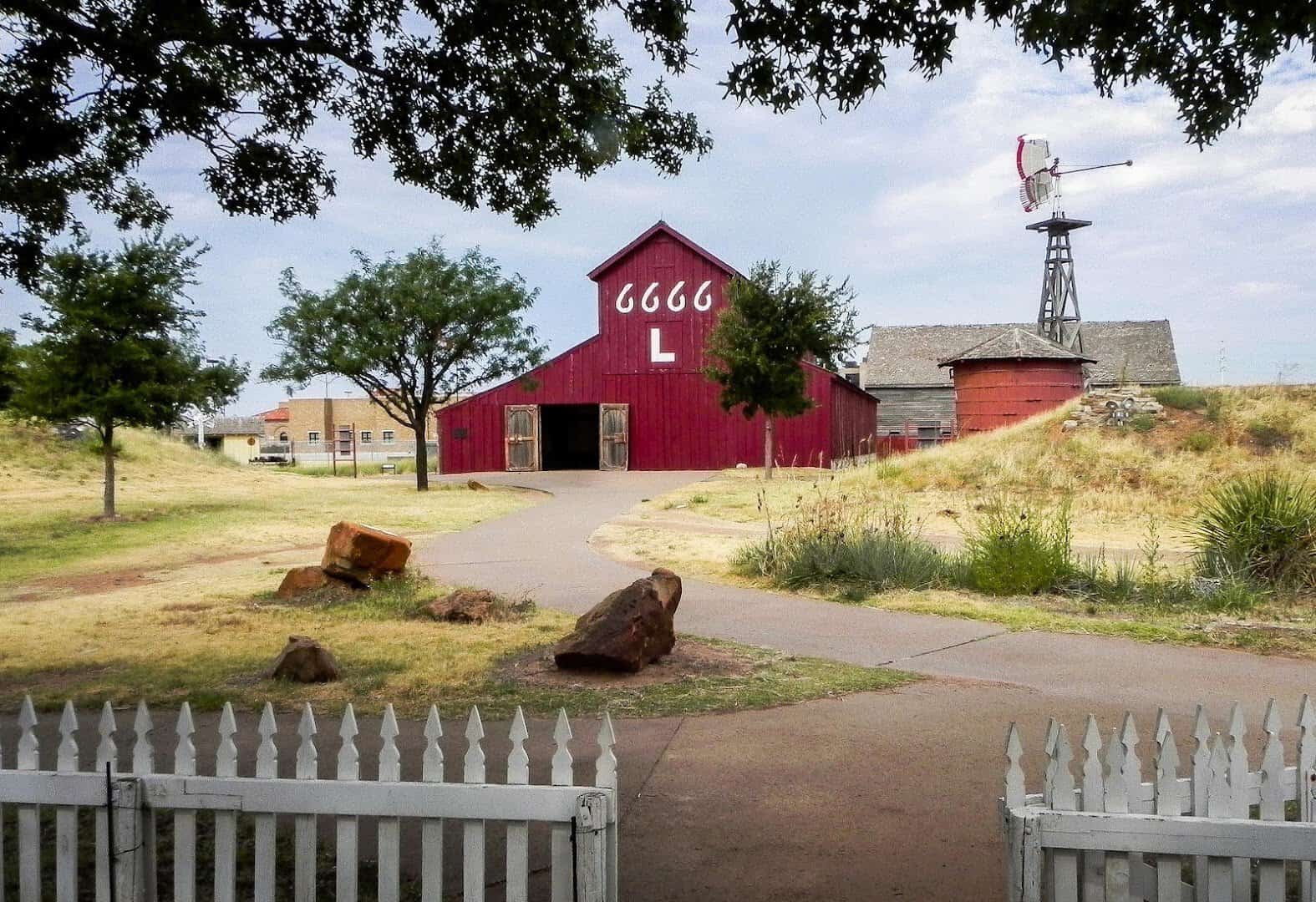 Historic red ranch barn and windmill at the National Ranching Heritage Center in Lubbock, Texas