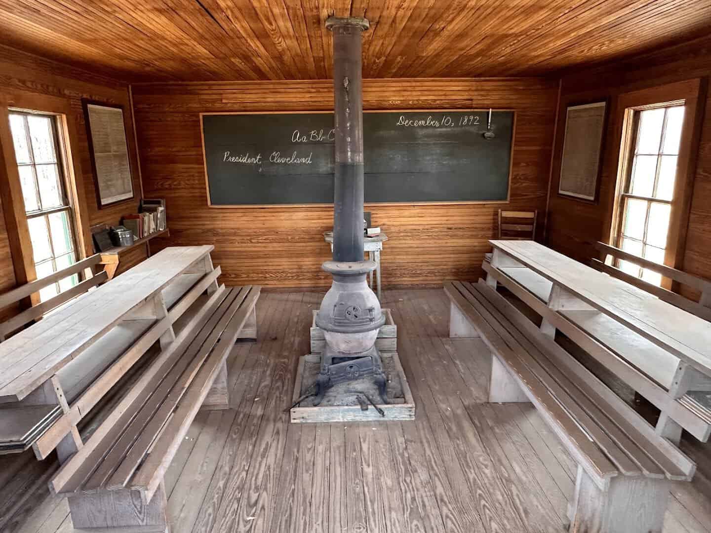 Interior of a one-room schoolhouse with a wood stove at the National Ranching Heritage Center in Lubbock, Texas