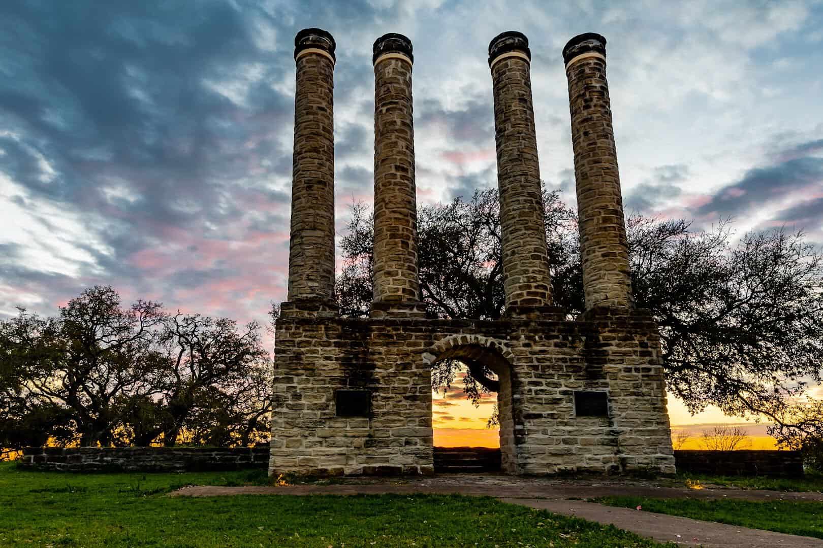 Four stone columns of the old Baylor University at sunset in Old Baylor Park, Independence, Texas