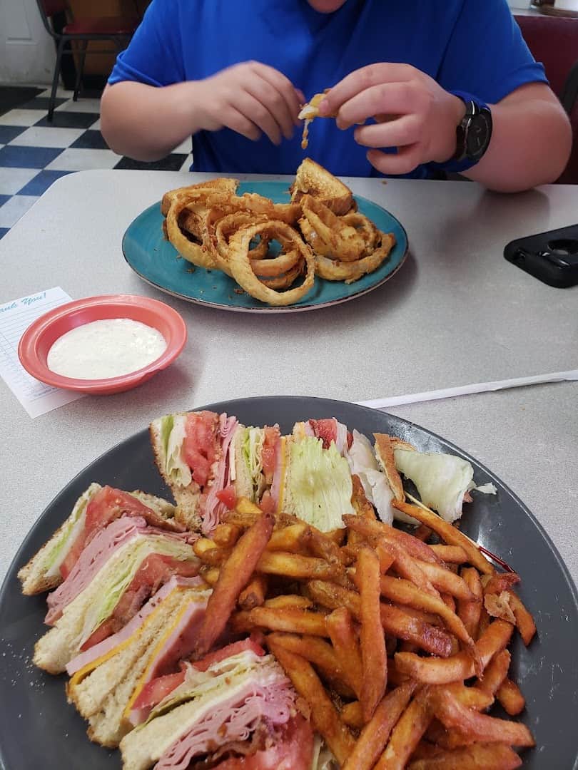 Onion rings and a club sandwich with sweet potato fries at Whistle Stop Cafe in Decatur, Texas