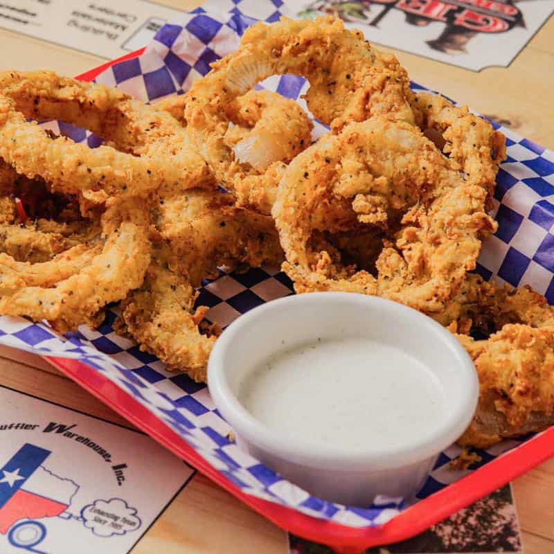 Golden onion rings and fried tenders in a basket at Hill Country Cupboard