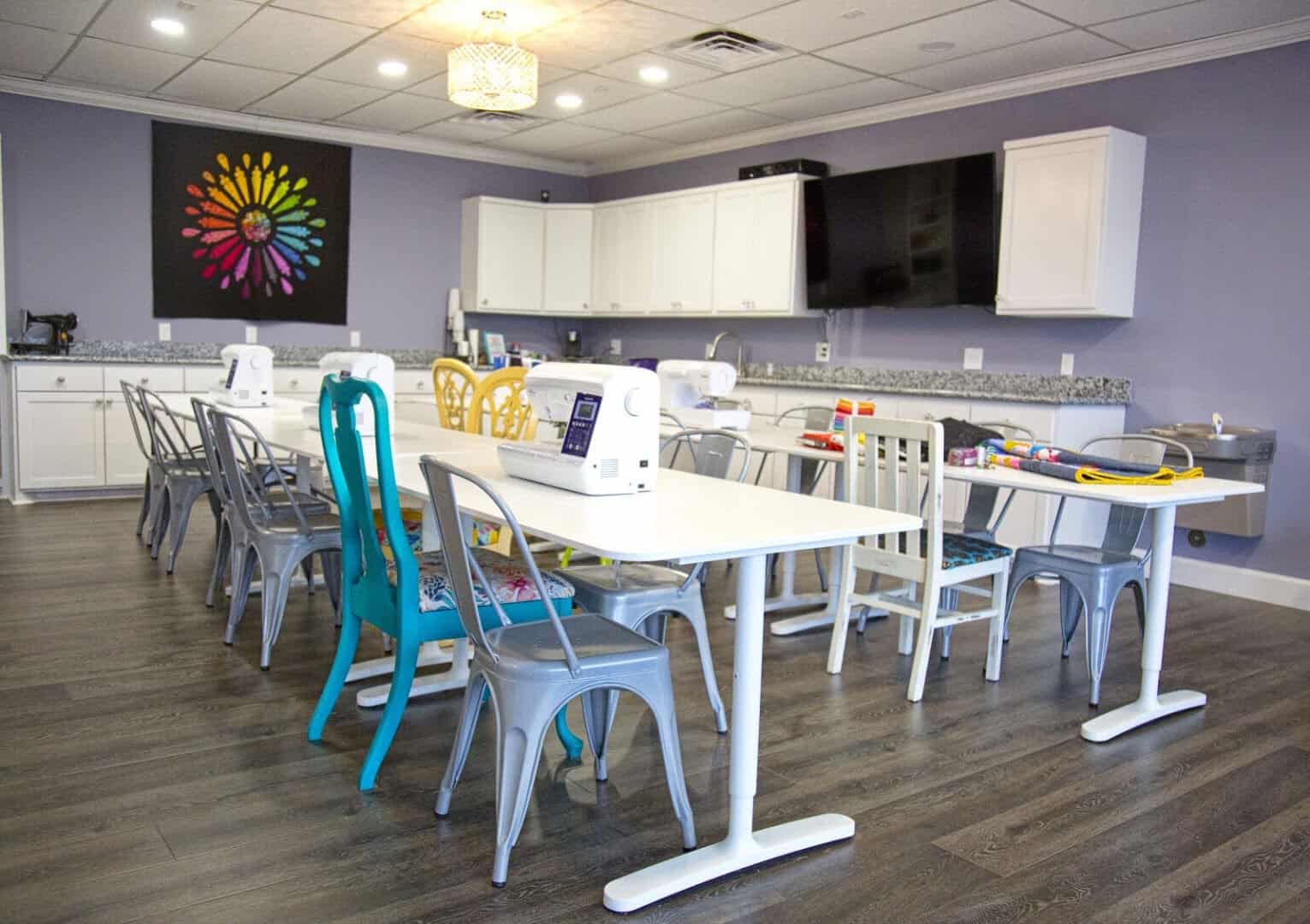 Bright crafting studio with worktables and sewing machines at The Sparkly Elephant Sewing Lounge in Friendswood, Texas