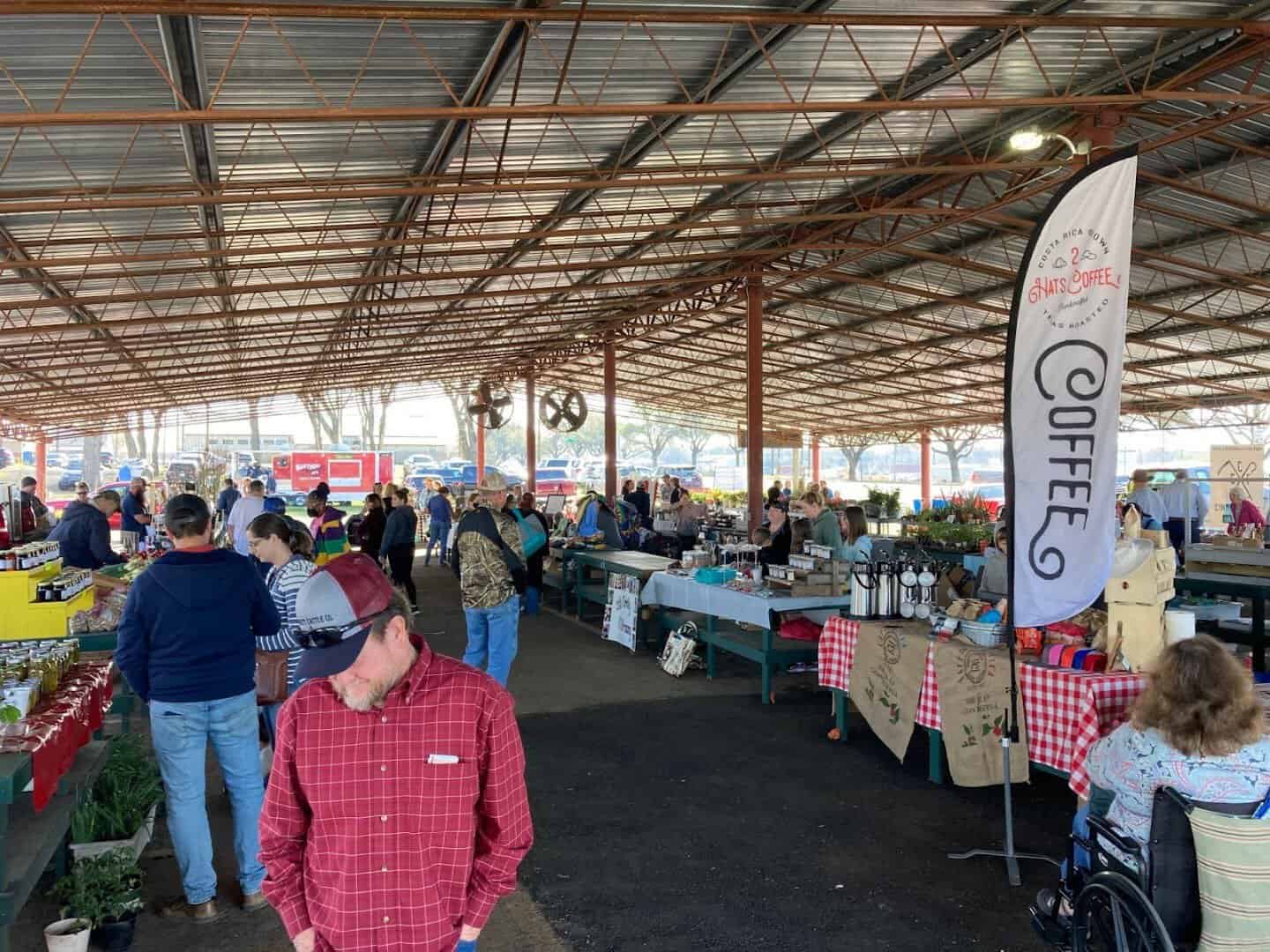 Shoppers filling the covered pavilion at the Palestine Farmers Market in Palestine, Texas