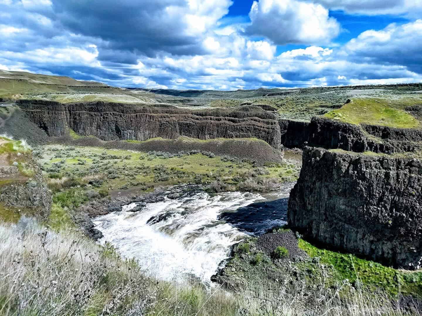 Palouse Falls dropping into its basalt amphitheater under dramatic sky, eastern Washington