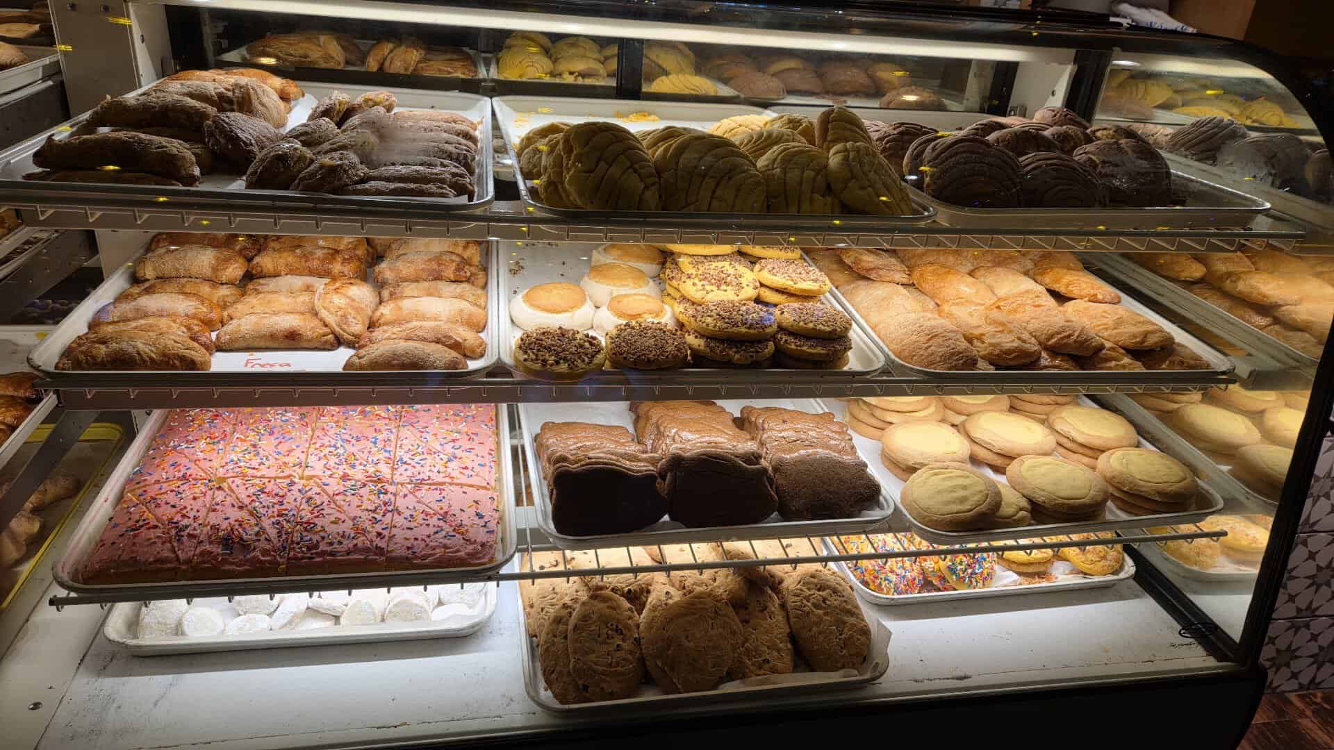 Glass bakery case filled with conchas and pan dulce at Mi Familia at the Rim in San Antonio