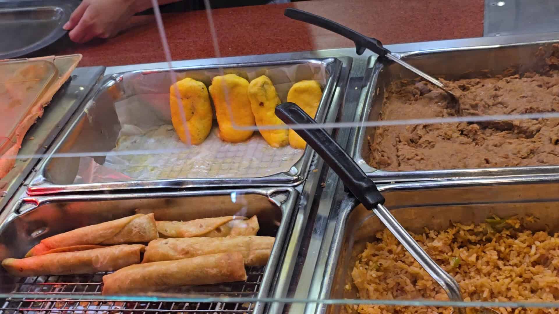 Chile rellenos and flautas on the buffet steam table at Pancho's Mexican Buffet in Mesquite, Texas