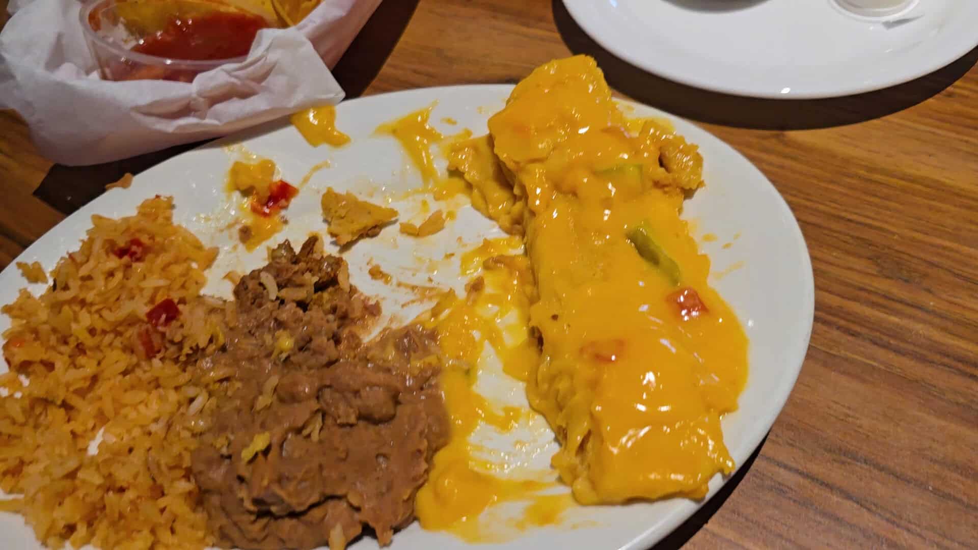 A cheese enchilada with rice and refried beans at Pancho's Mexican Buffet in Mesquite, Texas