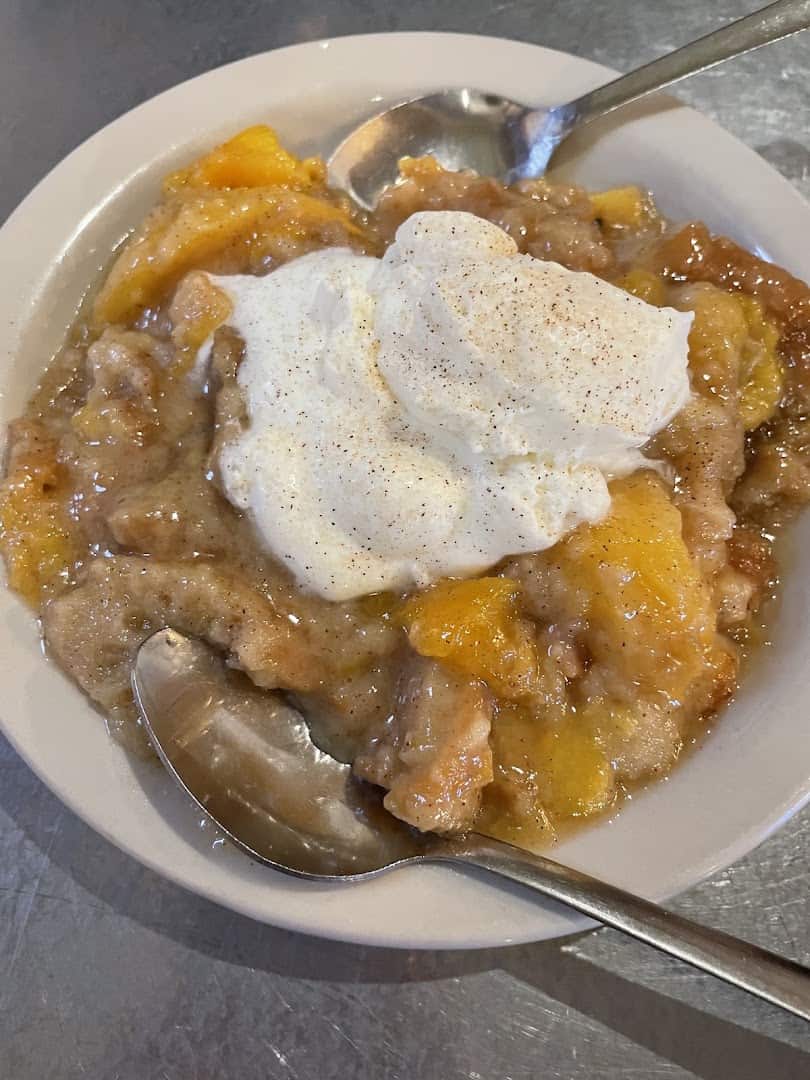 Peach bread pudding with whipped cream at Rathskeller Bistro in Fredericksburg