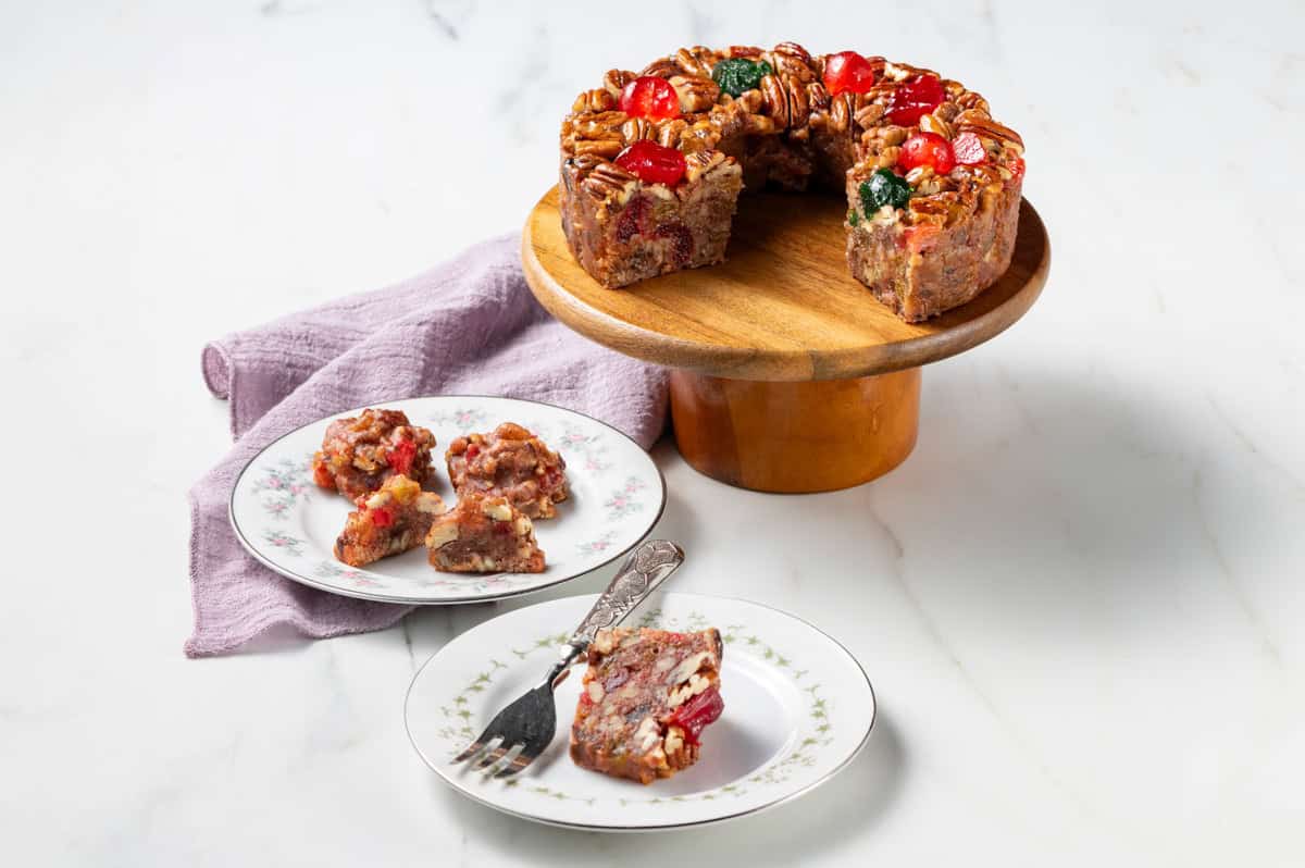 Texas pecan cake on a white cake stand at Collin Street Bakery