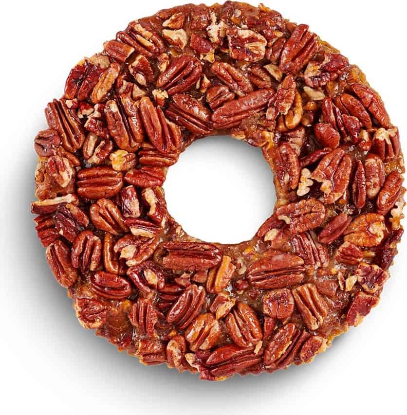 Top view of a Texas pecan cake covered in pecan halves at Collin Street Bakery