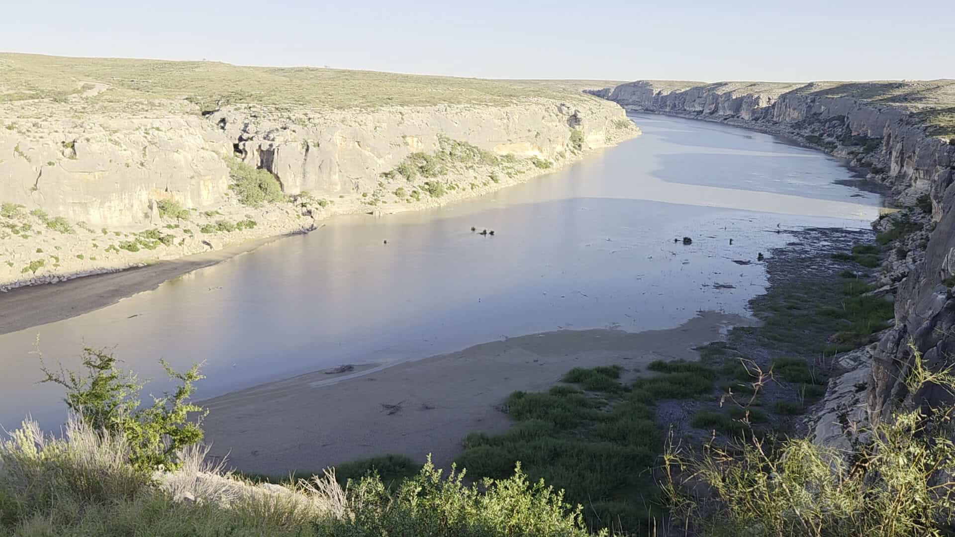 Pale limestone canyon walls of the Pecos River near the US 90 bridge in Texas