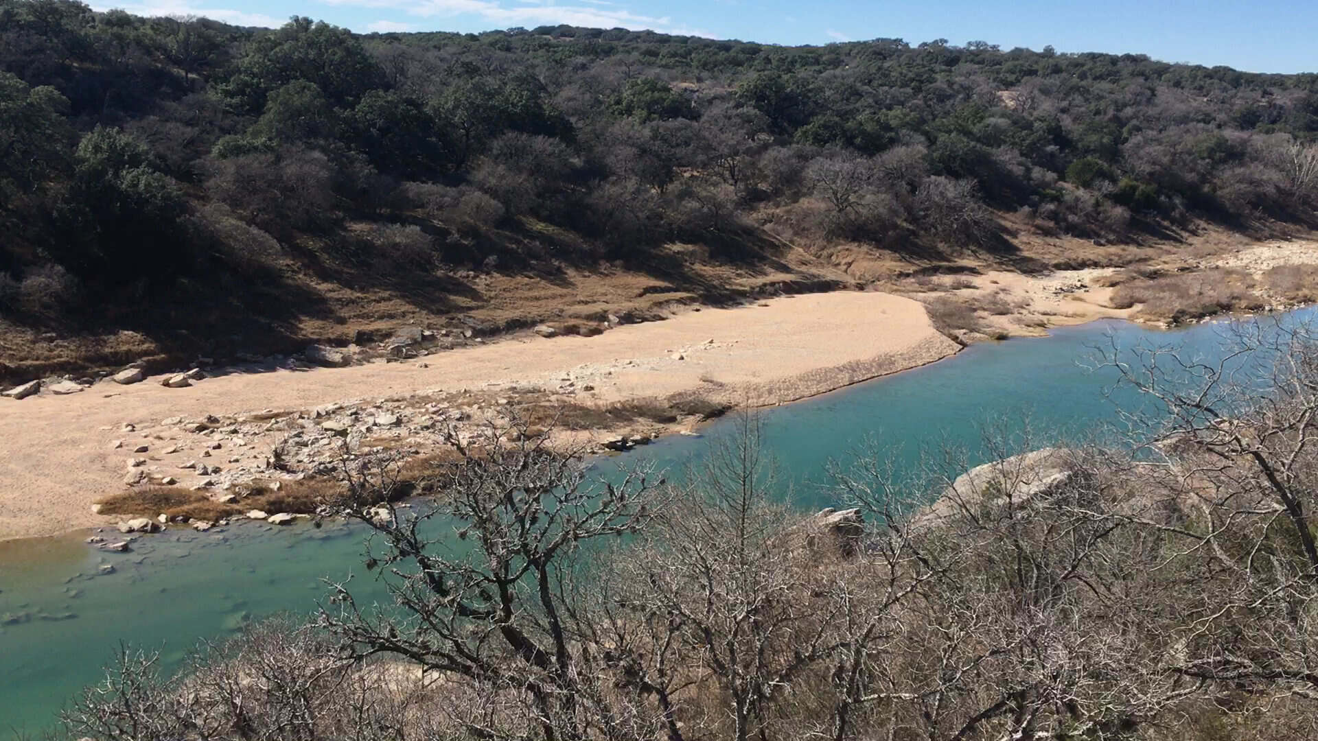 Turquoise Pedernales River and sandy bank for wading at Milton Reimers Ranch Park