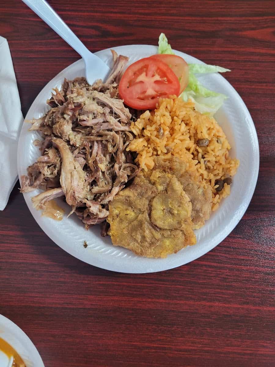 Roasted pernil with yellow rice and tostones at El Flamboyan in Wylie, Texas