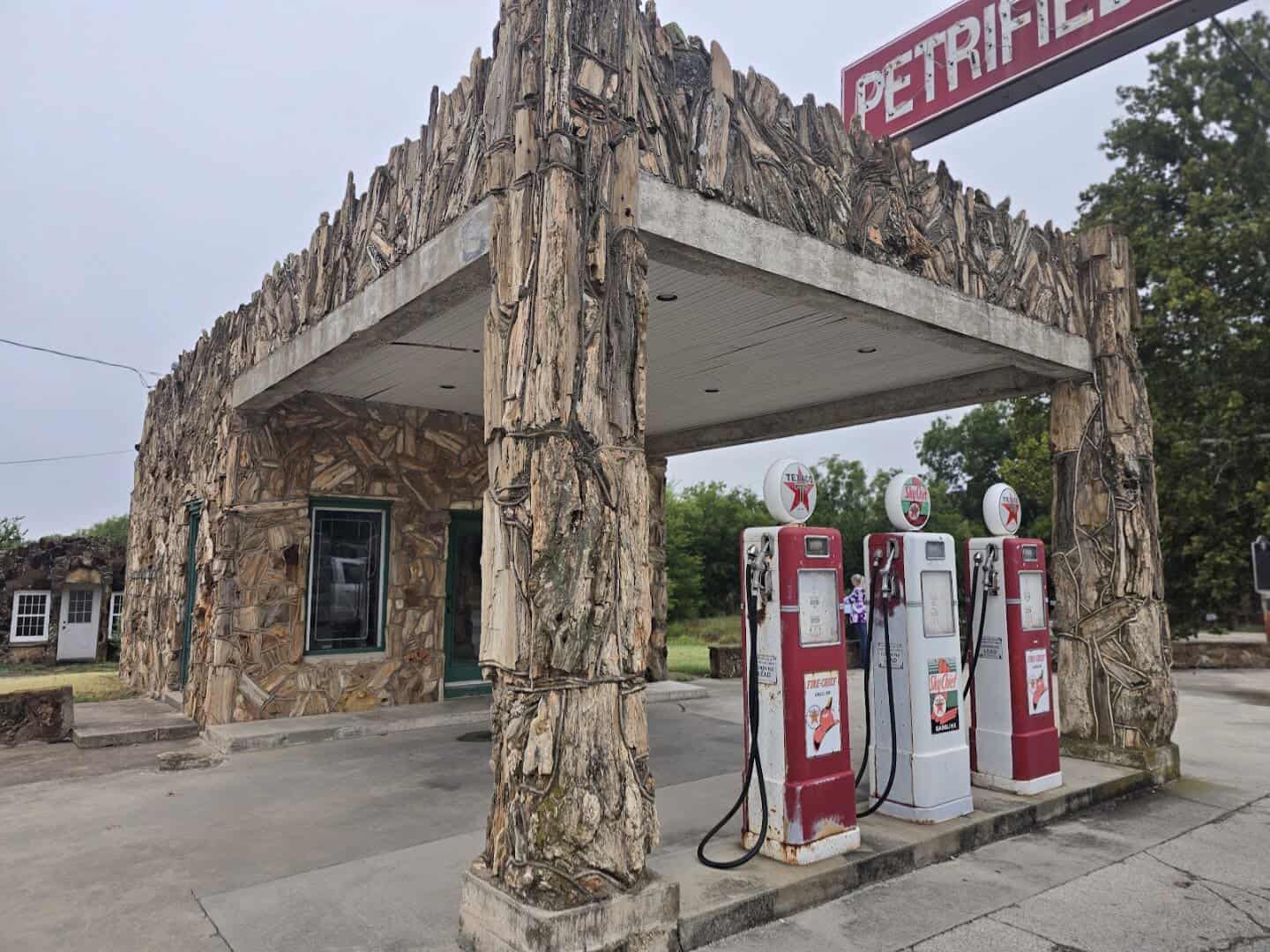 Petrified wood filling station with vintage gas pumps at the Texas Tourist Camp in Decatur, Texas