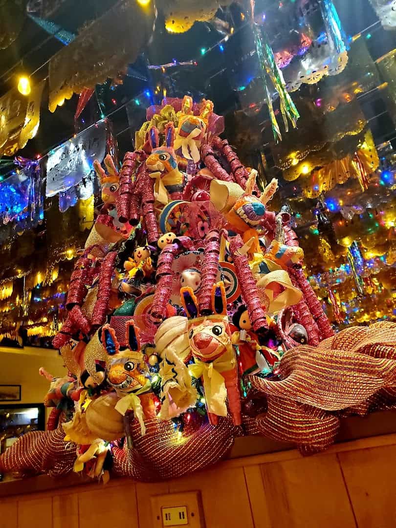 Pinatas and papel picado hanging from the ceiling at Mi Familia at the Rim in San Antonio