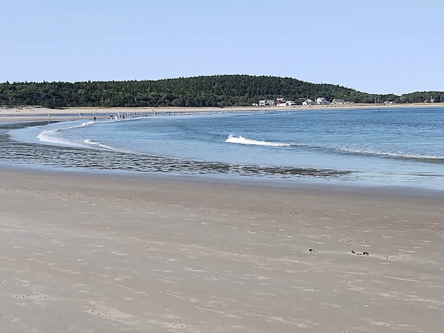 The wide sweep of sand and surf at Popham Beach State Park in Phippsburg, Maine