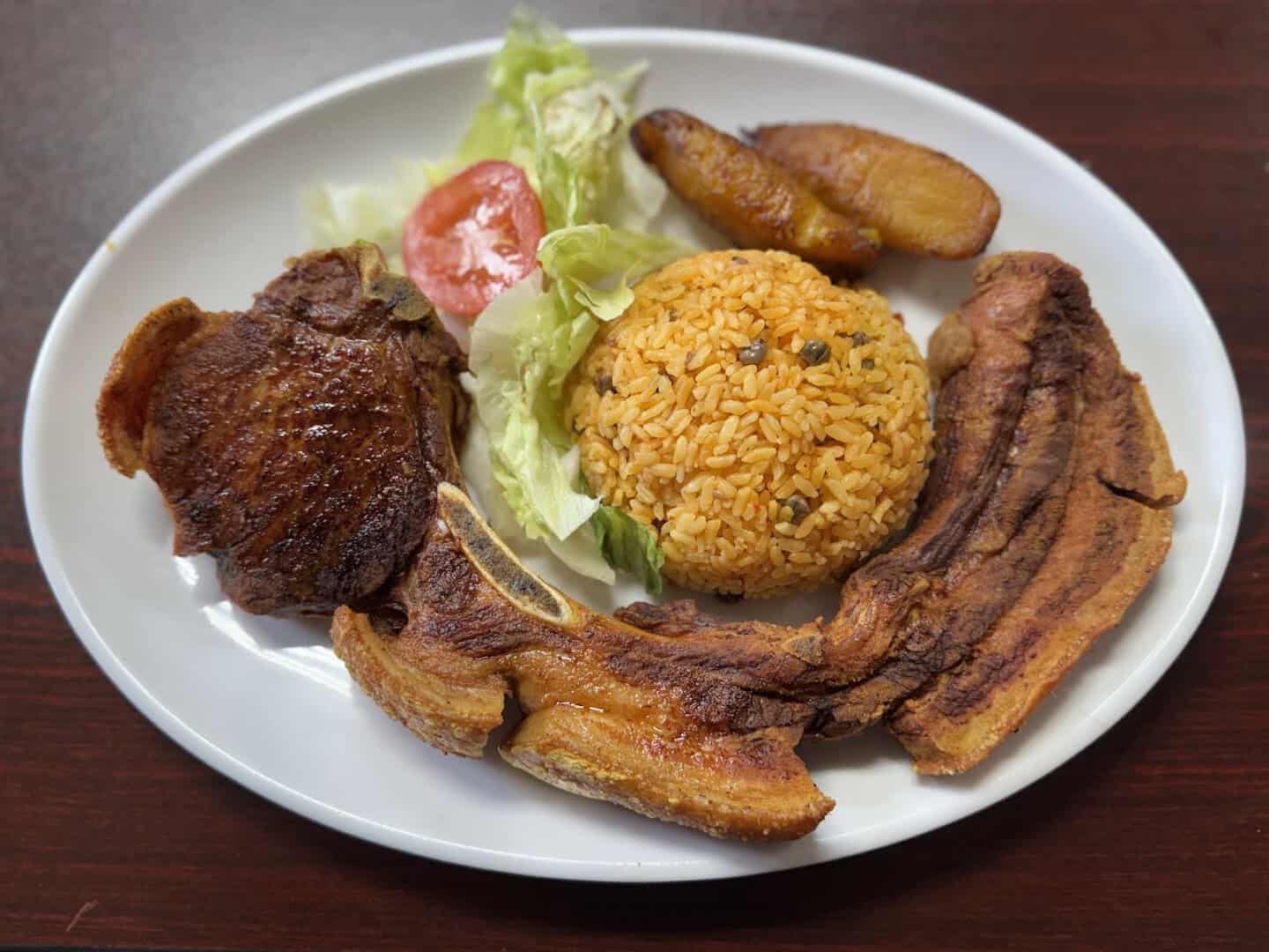 Roasted pork chop with yellow rice and sweet plantains at El Flamboyan in Wylie, Texas
