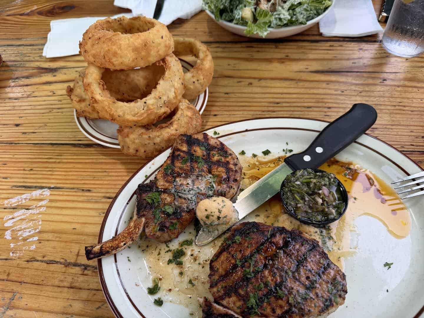 Grilled pork chops with a tower of onion rings at Gruene River Grill in New Braunfels