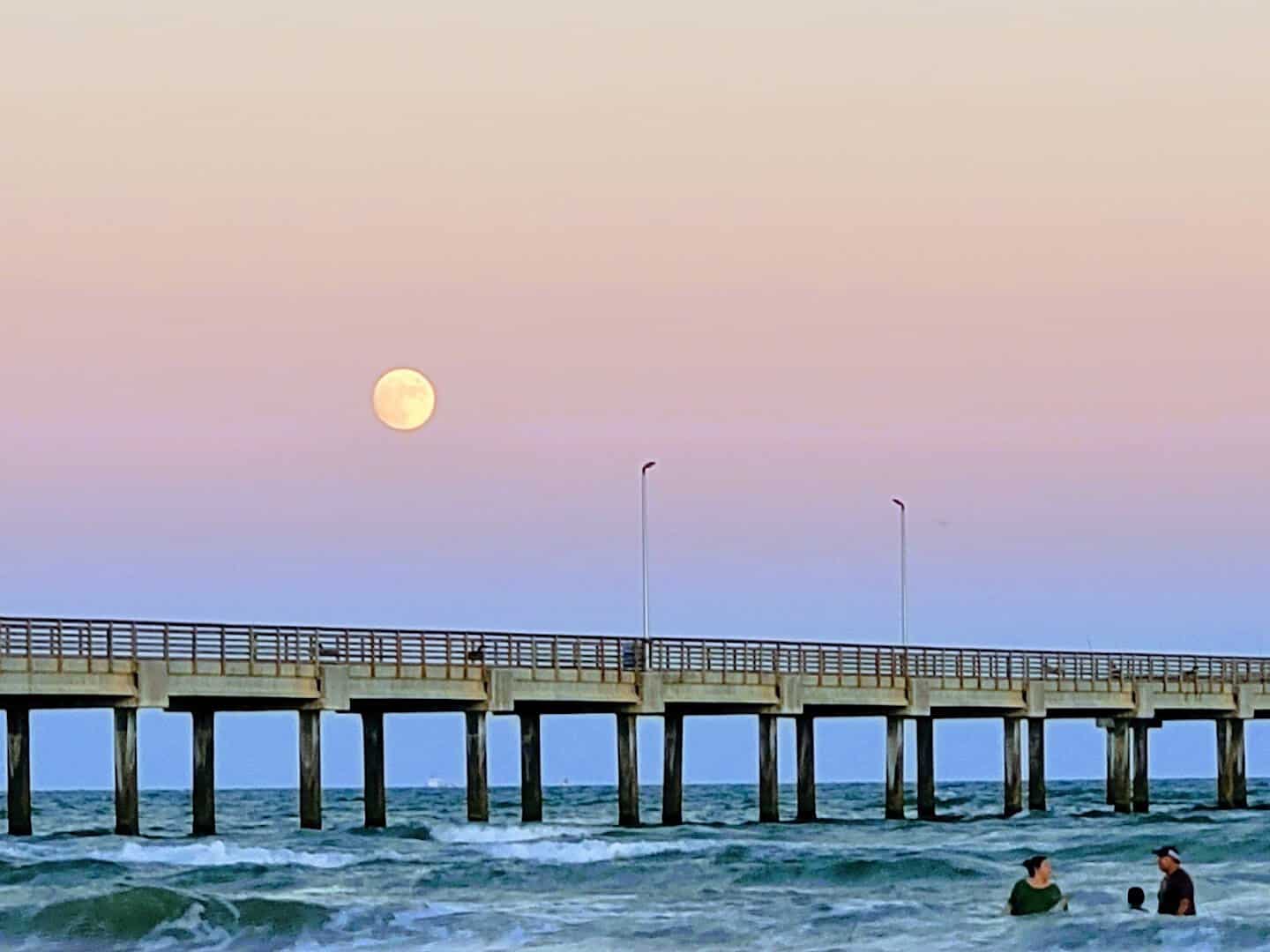 Pink sunset over the pier at Port Aransas Beach, Texas