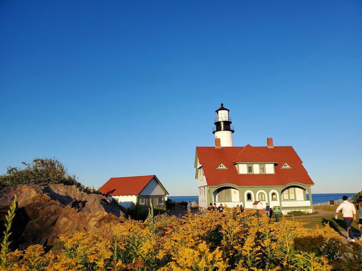 Portland Head Light tower and keeper's house with autumn wildflowers in Cape Elizabeth, Maine