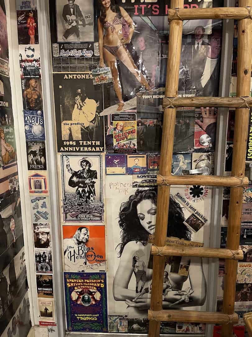Wall covered in vintage music posters and clippings at Sigs Lagoon in Houston