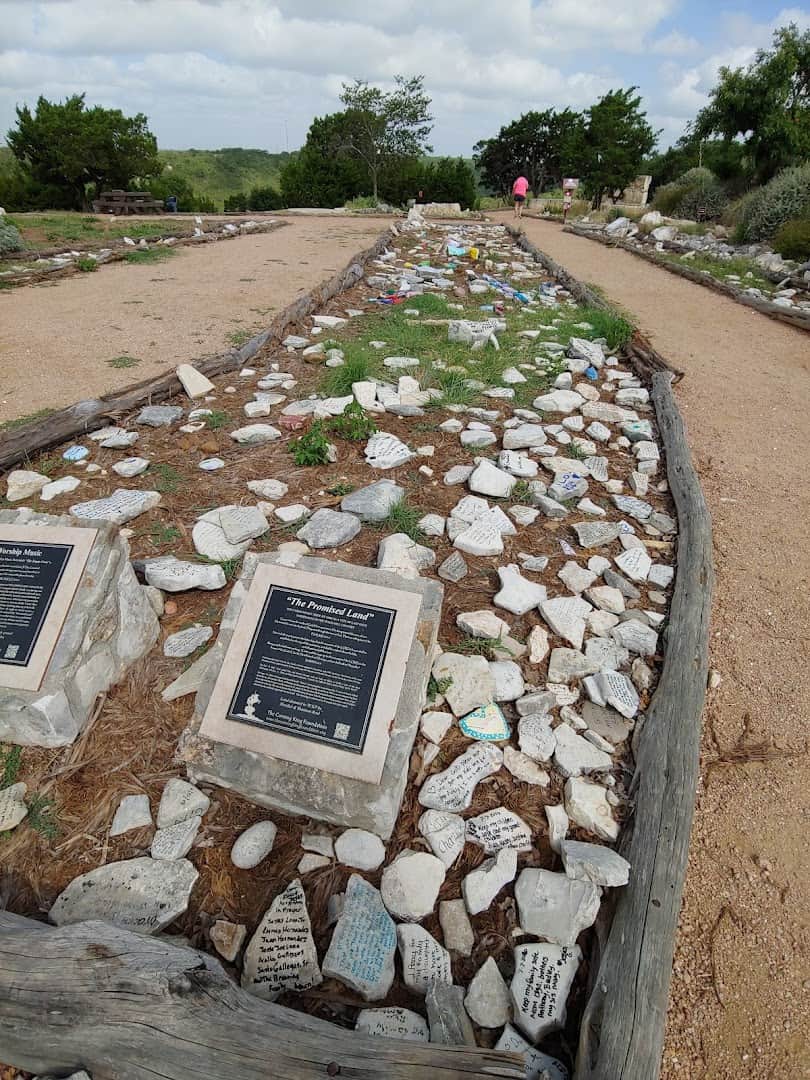 Prayer Path lined with thousands of written prayer rocks at the Coming King Sculpture Prayer Garden