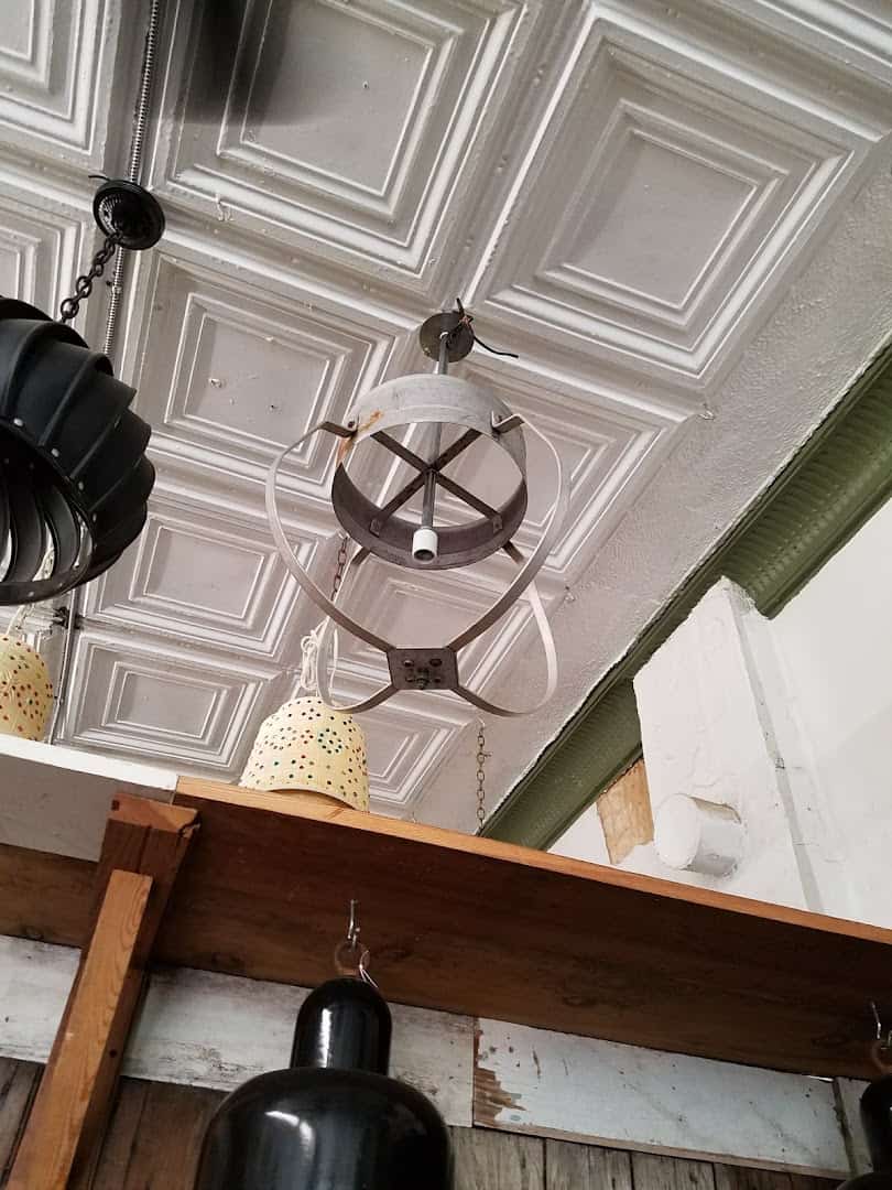 Antique pressed tin ceiling panels and hanging lights at Old Home Supply House in Fort Worth