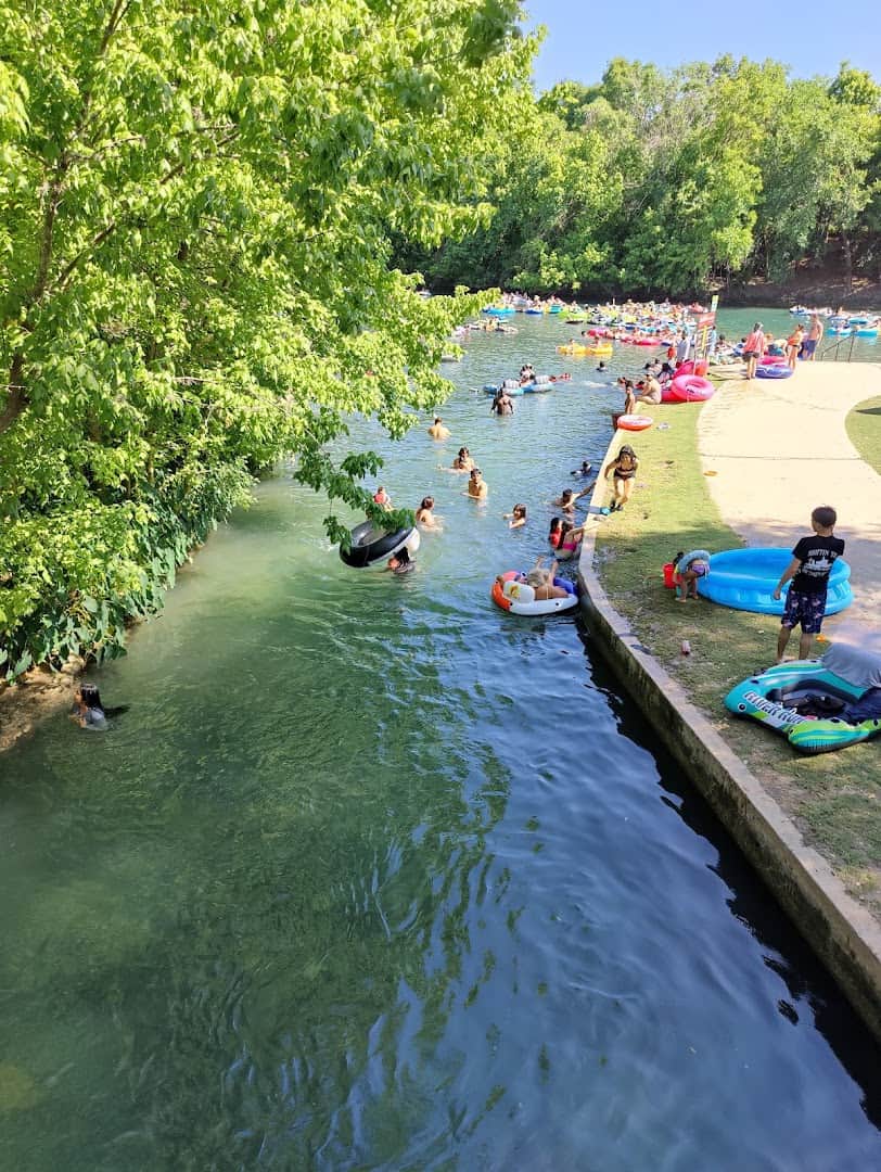Tubers floating down the City Tube Chute on the Comal River at Prince Solms Park in New Braunfels, Texas