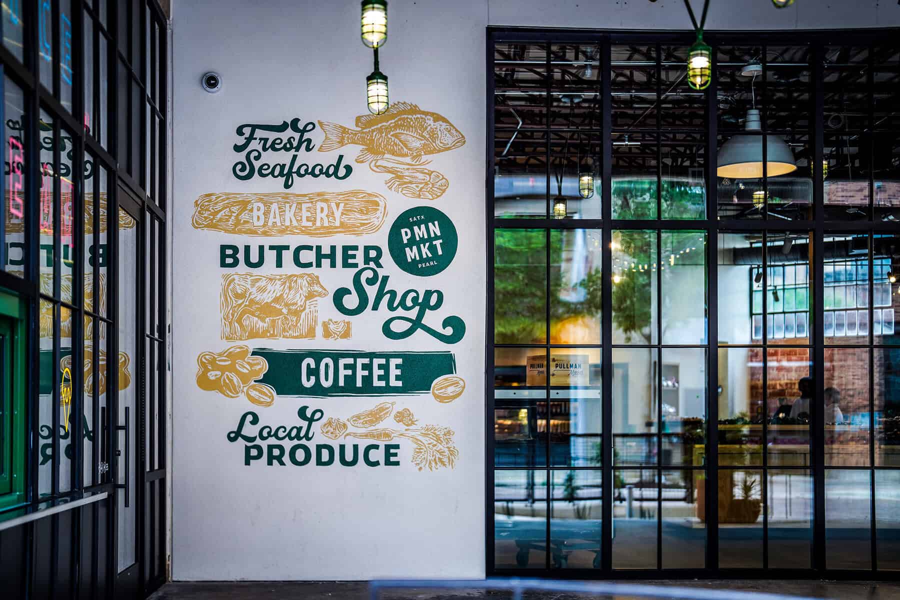 Signage inside Pullman Market listing seafood, bakery, butcher, coffee and produce