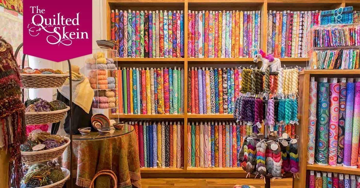 Shelves of colorful fabric bolts at The Quilted Skein in La Grange, Texas