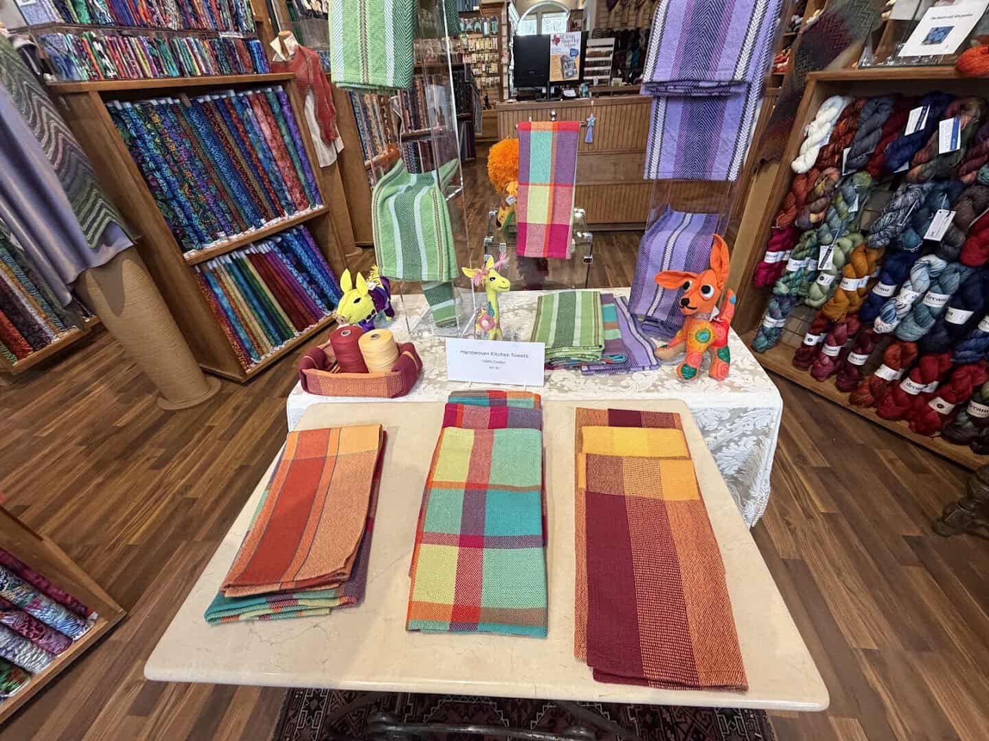 The large project table set with fabric at The Quilted Skein in La Grange, Texas