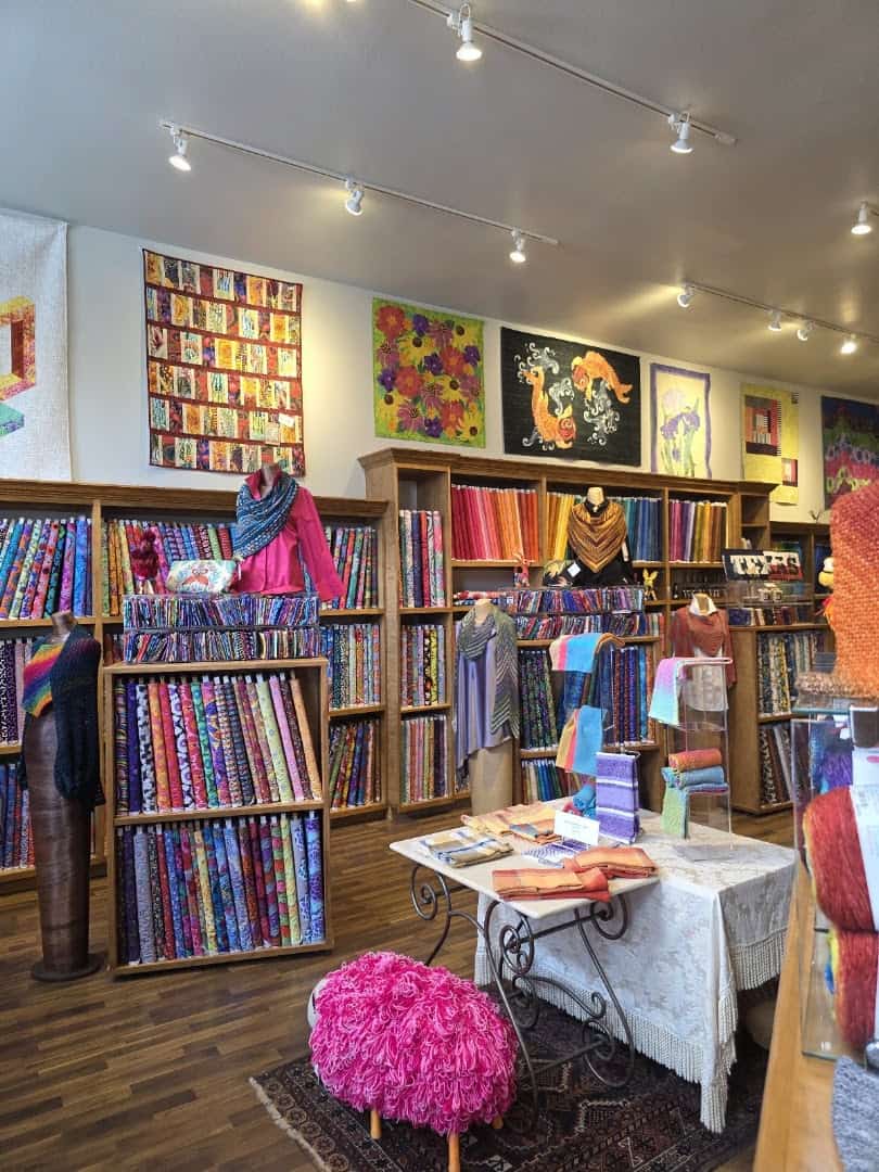 Quilts displayed on the wall inside The Quilted Skein in La Grange, Texas