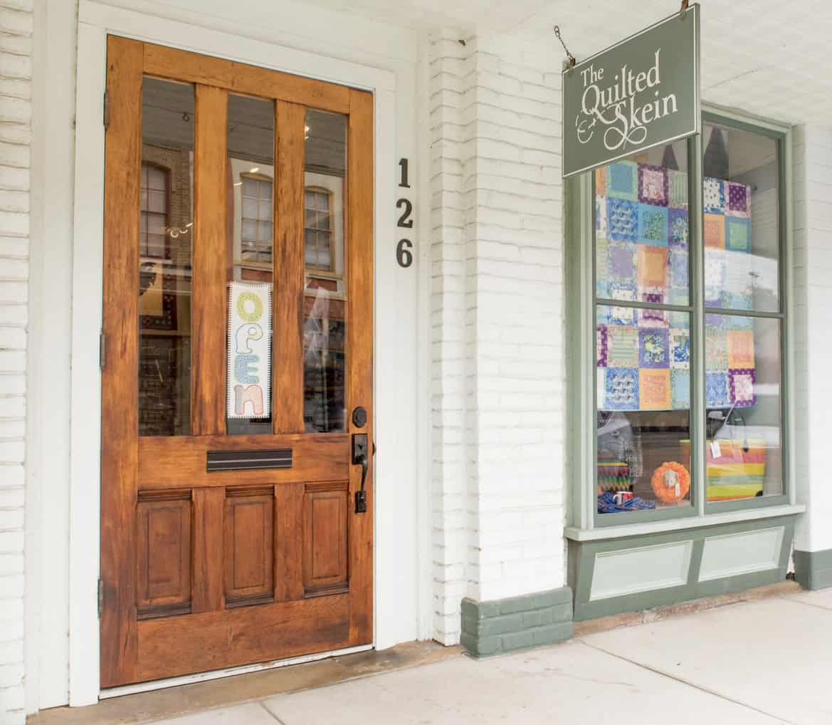 The Quilted Skein storefront and sign on Colorado Street in La Grange, Texas