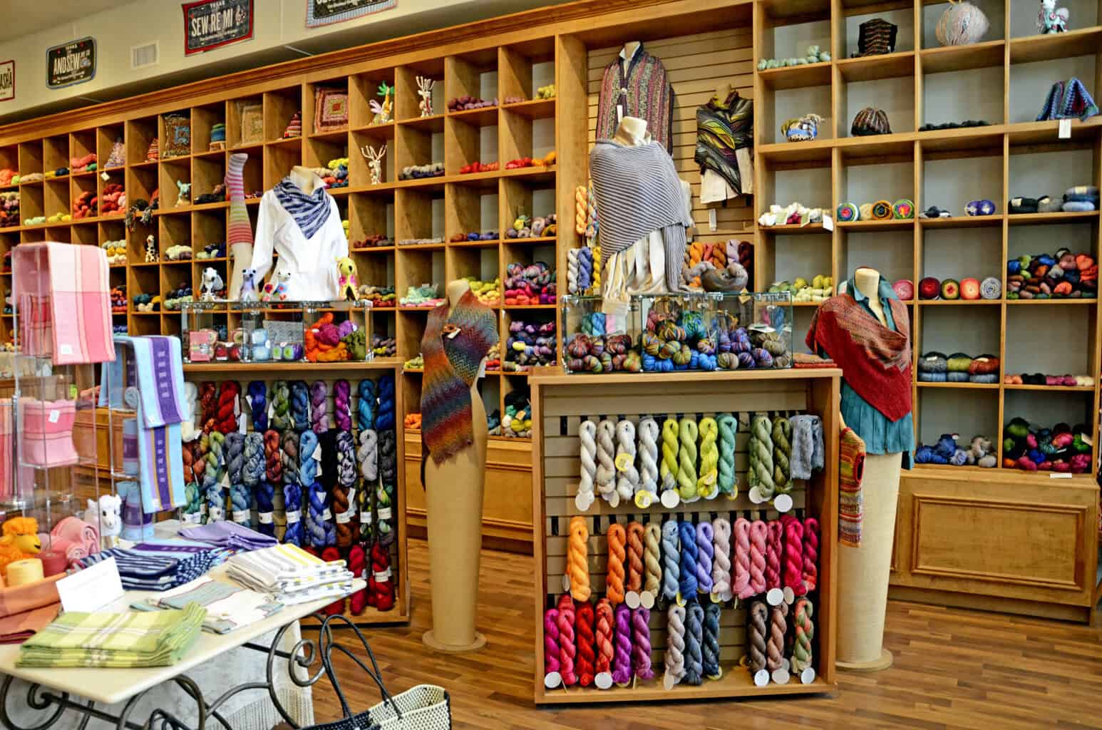 Warm wooden interior with yarn shelves at The Quilted Skein in La Grange, Texas