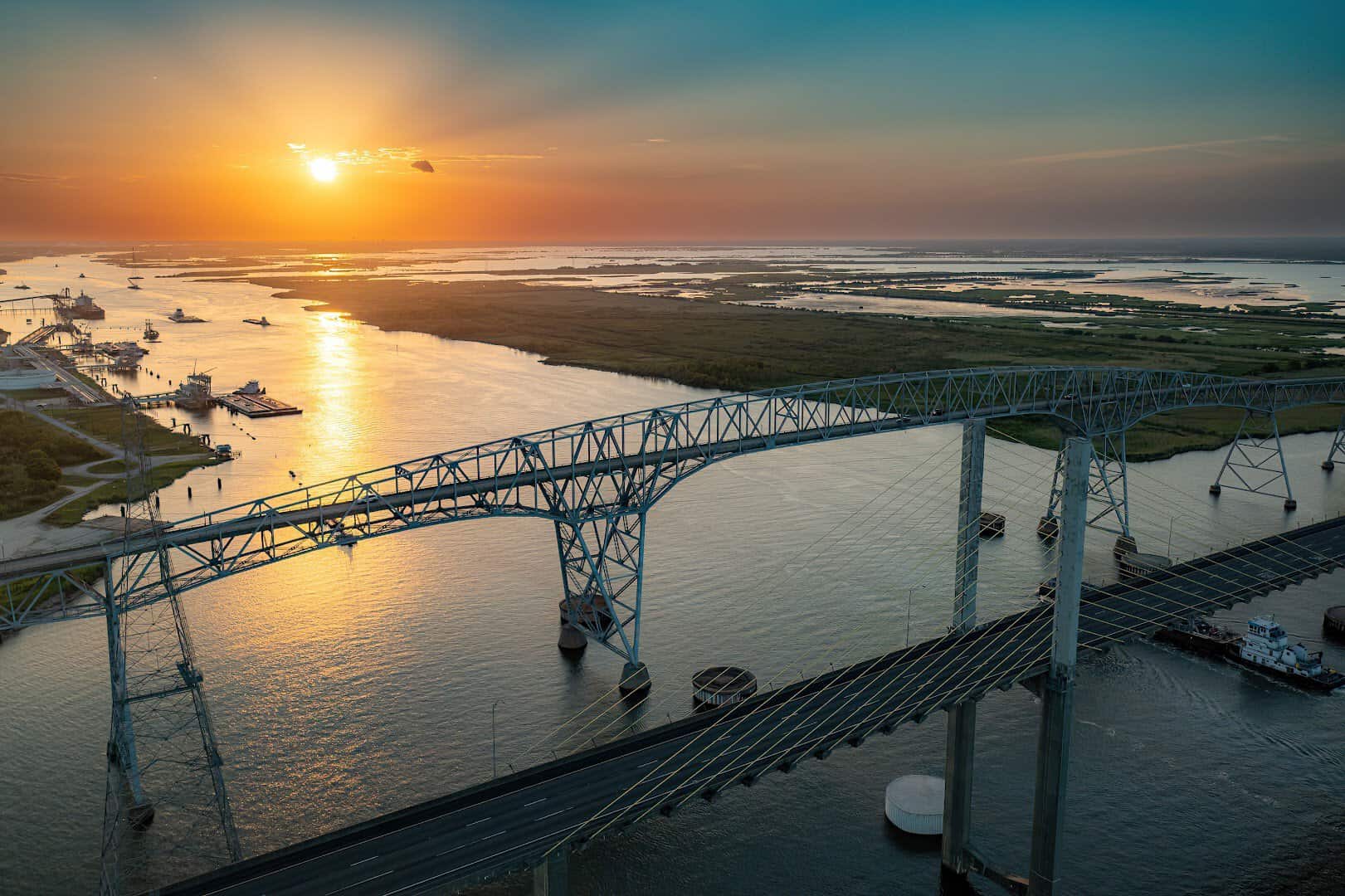 Sunset over the Neches River with the Rainbow Bridge silhouetted near Port Arthur, Texas