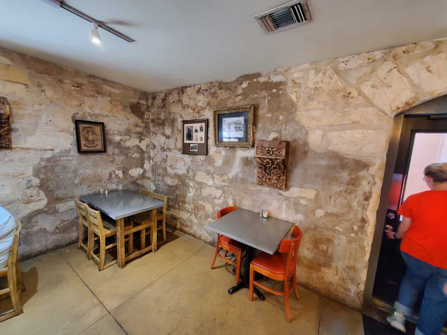 Stone walls and framed old photos inside the Rathskeller basement in Fredericksburg