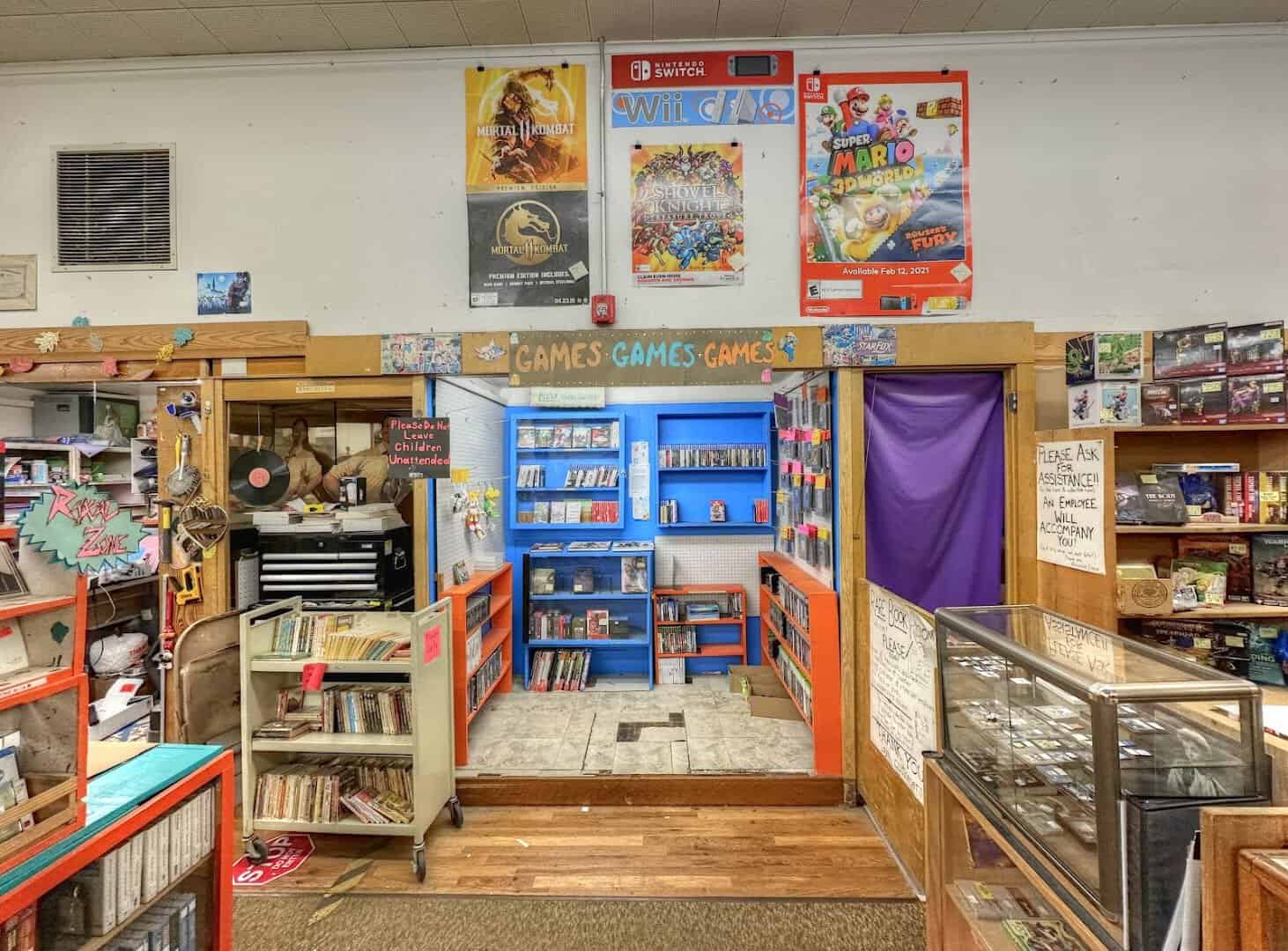 Colorful shelves of games and books at Recycled Books in Denton, Texas