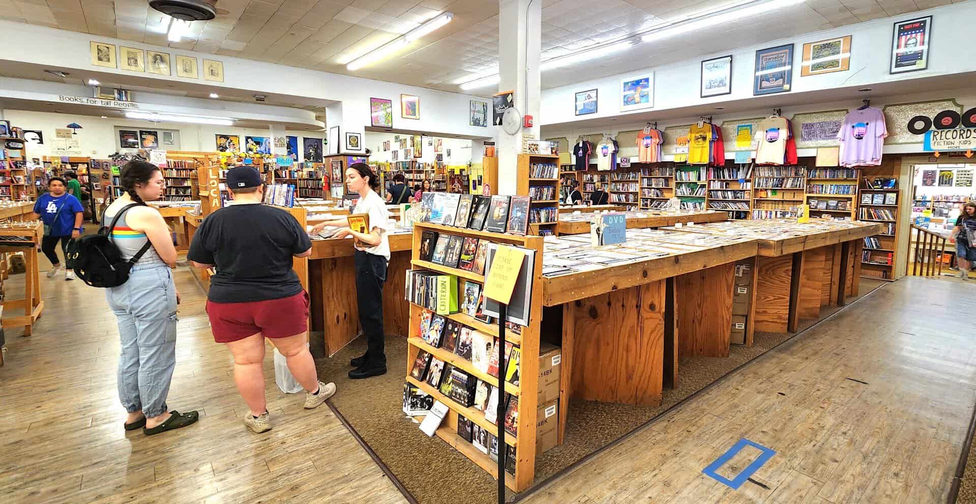 Shoppers browsing the crowded main floor of Recycled Books in Denton, Texas