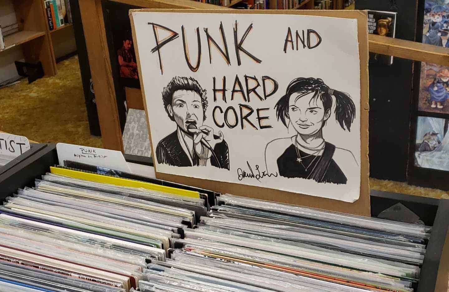 Hand-drawn Punk and Hardcore sign over record bins at Recycled Books in Denton, Texas