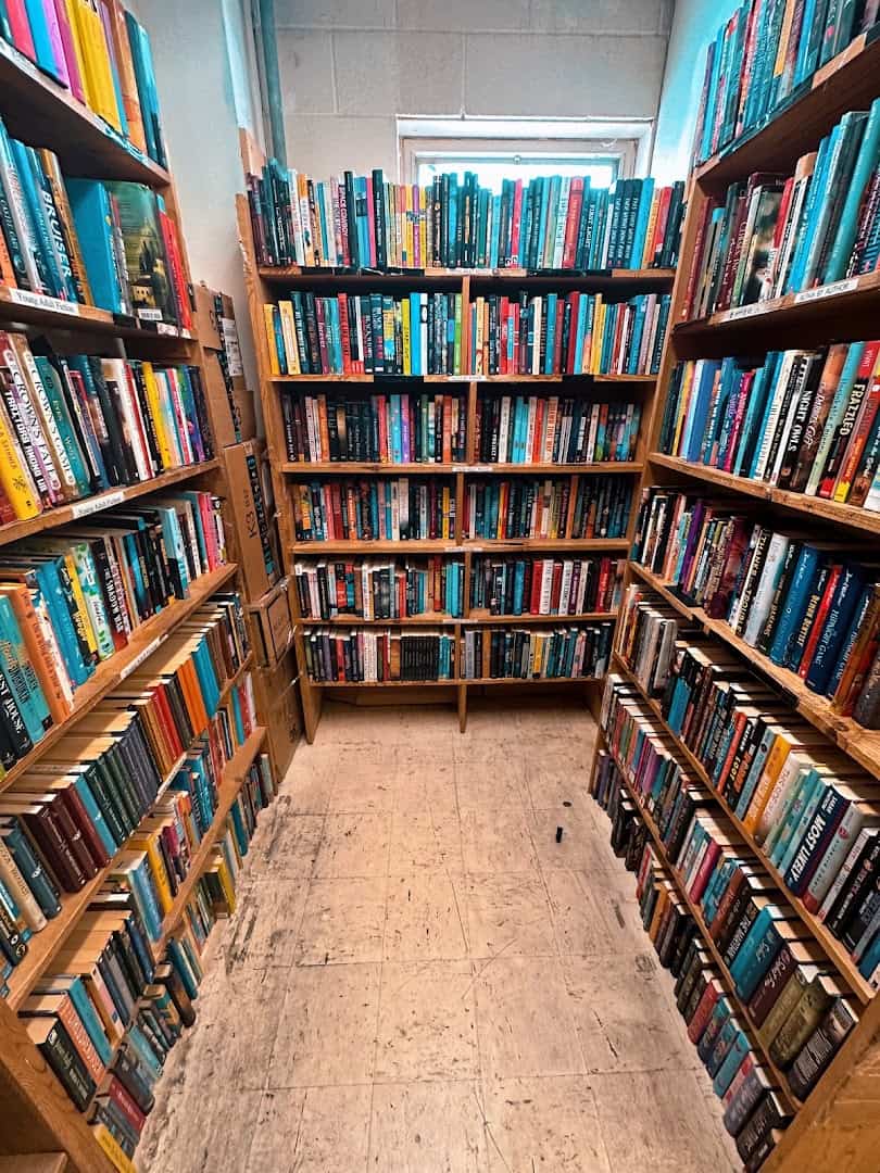 Tall aisle of used books at Recycled Books in Denton, Texas