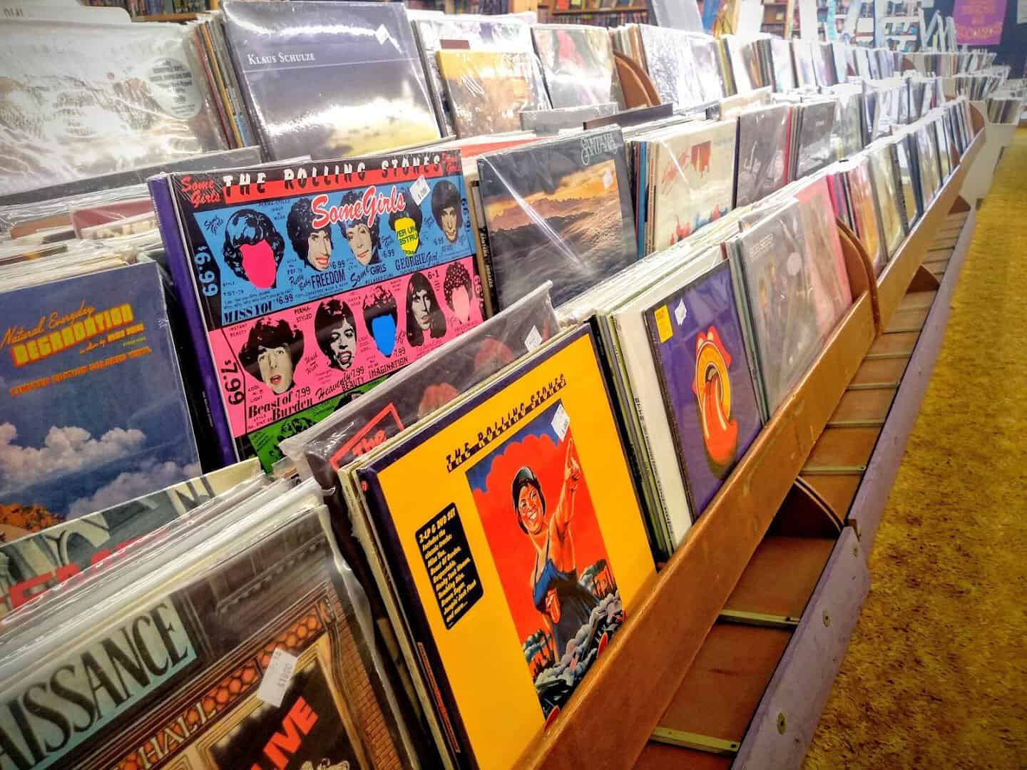 Long aisle of used vinyl records at Recycled Books in Denton, Texas