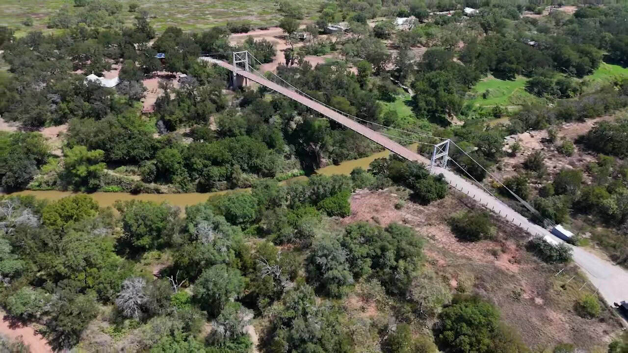 Aerial view of the Regency Suspension Bridge crossing the Colorado River near Regency, Texas