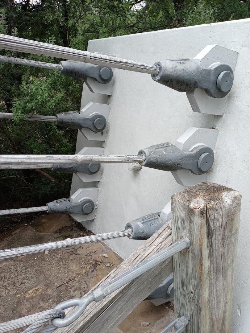 Steel suspension cables and anchor hardware on the Regency Bridge tower in Texas