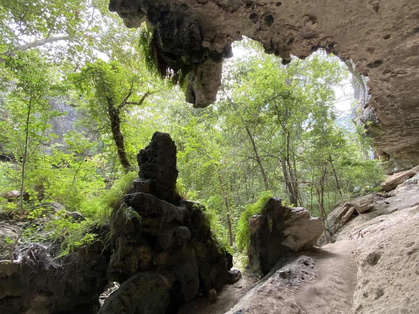 Weathered limestone overhang and grotto along a trail at Milton Reimers Ranch Park