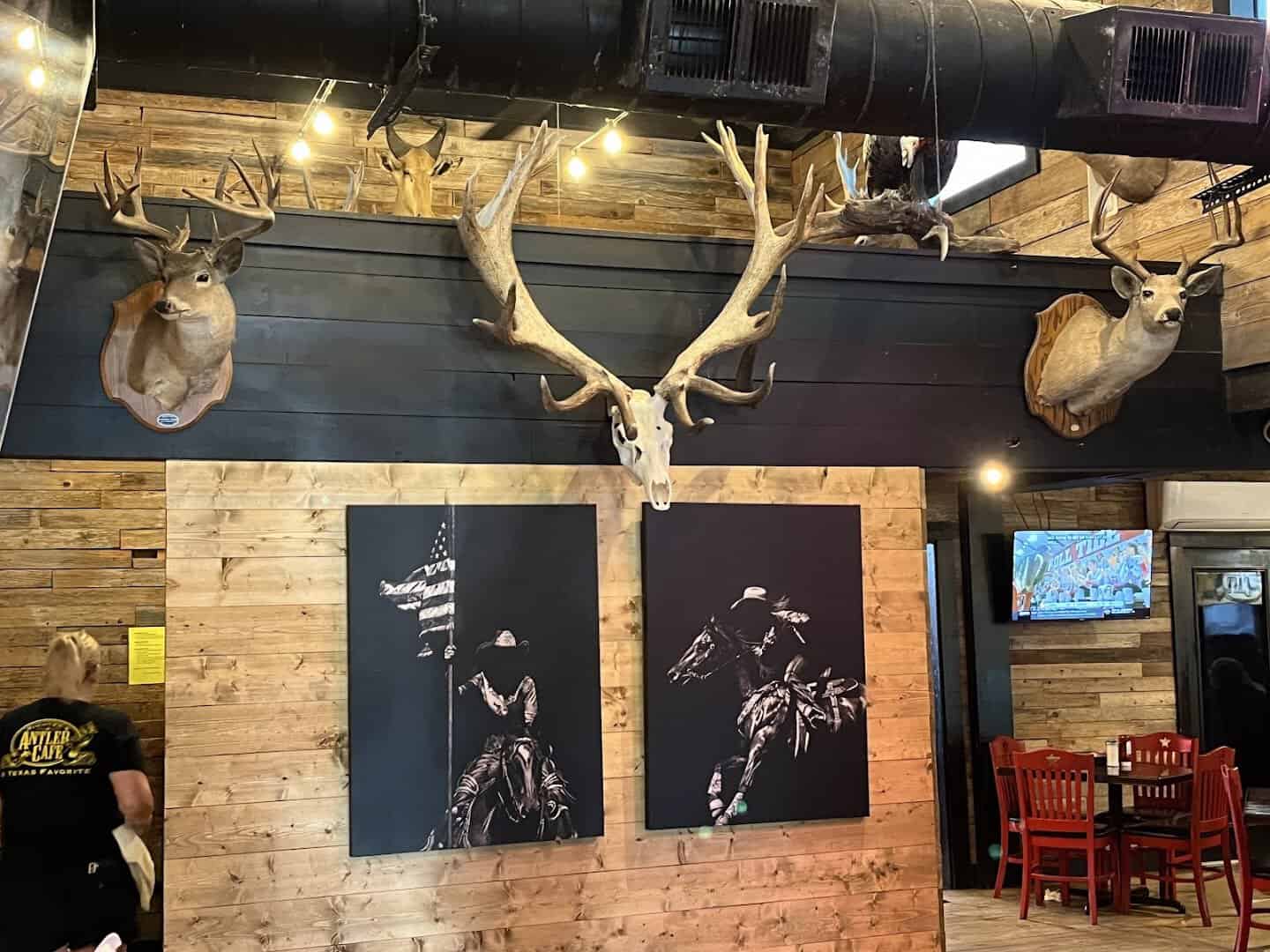 Antlers mounted on a brick wall beside the menu boards at Richter's Antler Cafe in Spring Branch, Texas