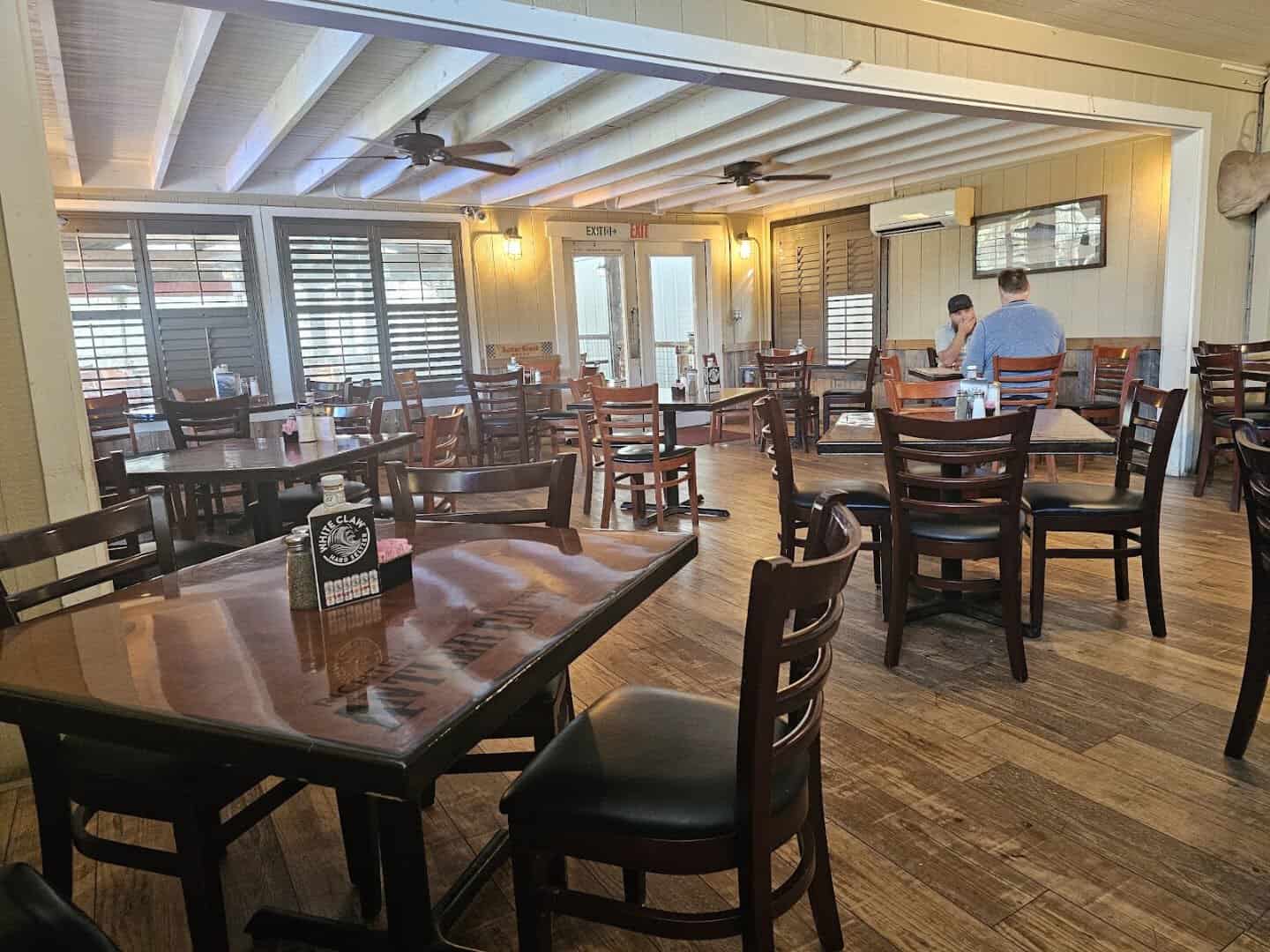 Bright wood-paneled dining room full of tables at Richter's Antler Cafe in Spring Branch, Texas