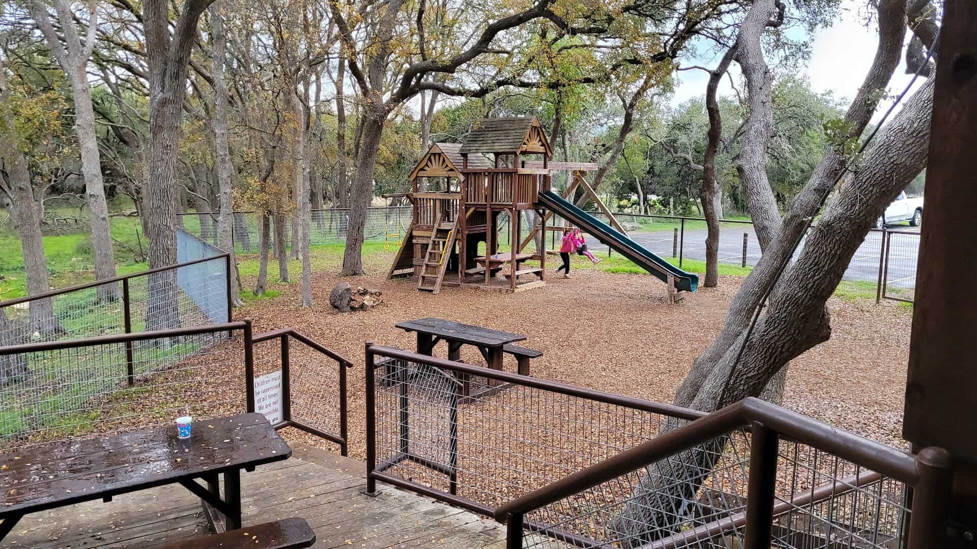 Shaded playground under the oak trees at Richter's Antler Cafe in Spring Branch, Texas