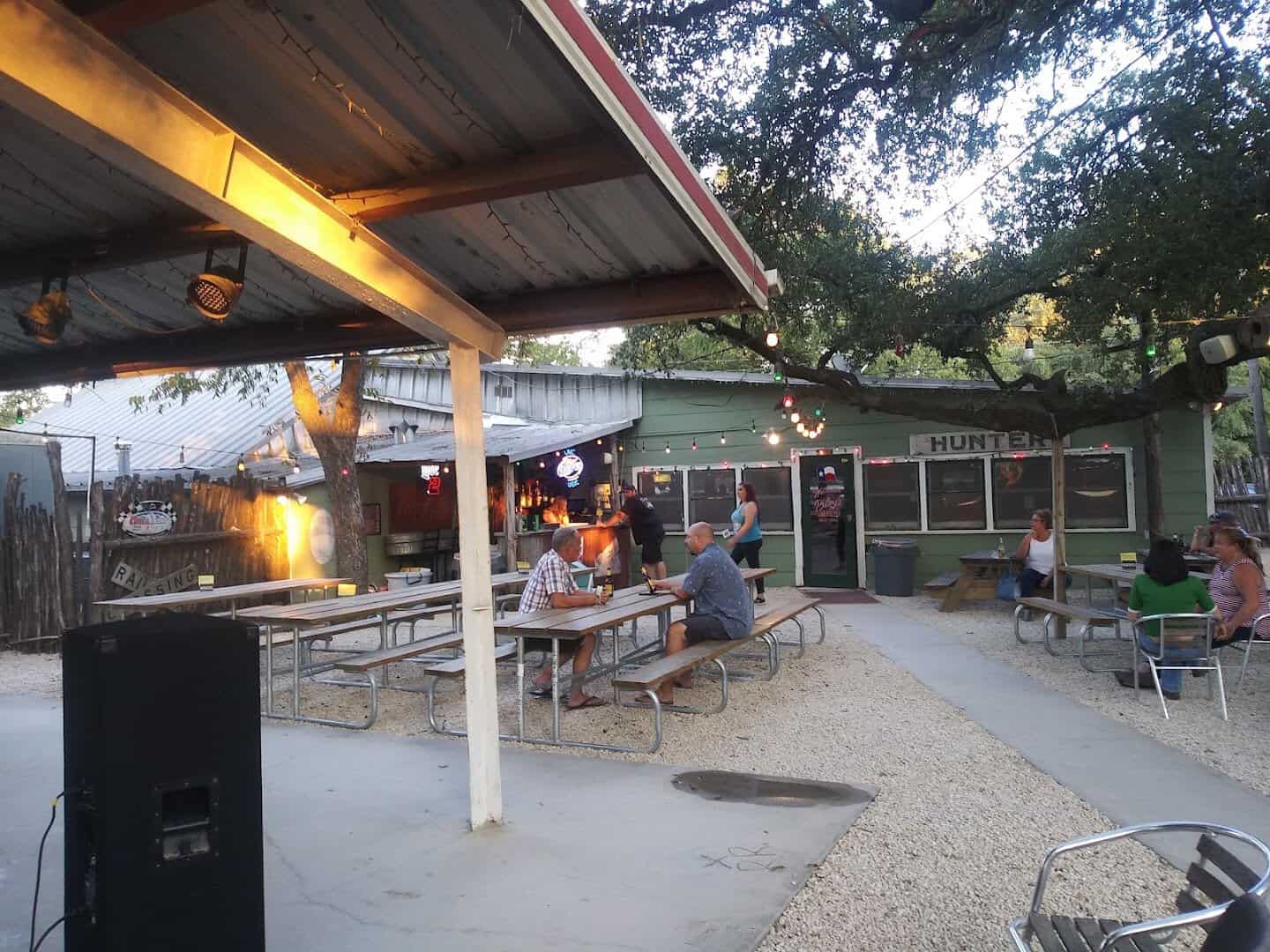 A crowd gathered in the covered beer garden for live music at Riley's Tavern in Hunter, Texas